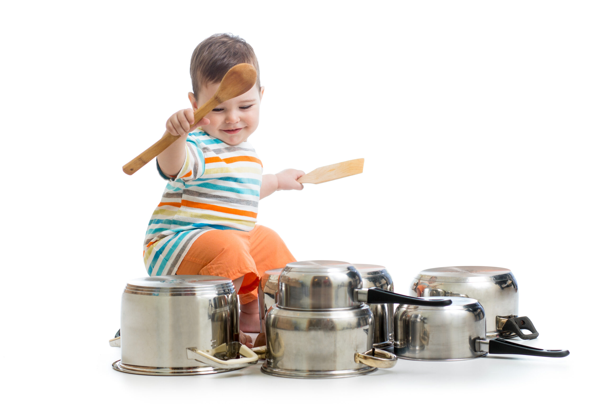 baby boy using wooden spoons to bang pans drumset